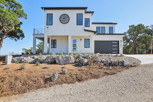 view of front of house featuring a balcony and a garage