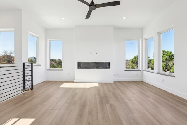 unfurnished living room with light hardwood / wood-style flooring and ceiling fan