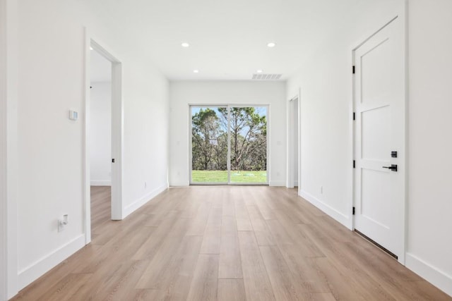 spare room featuring light wood-type flooring