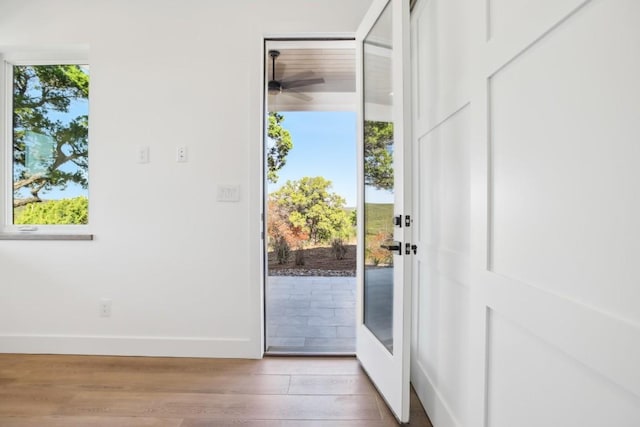 doorway featuring light hardwood / wood-style flooring and ceiling fan