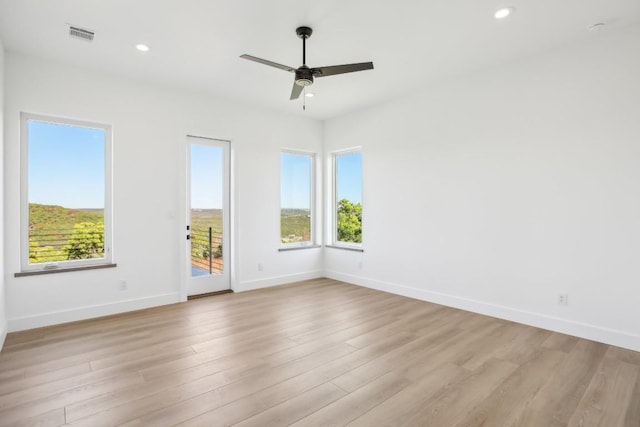 empty room featuring ceiling fan and light wood-type flooring