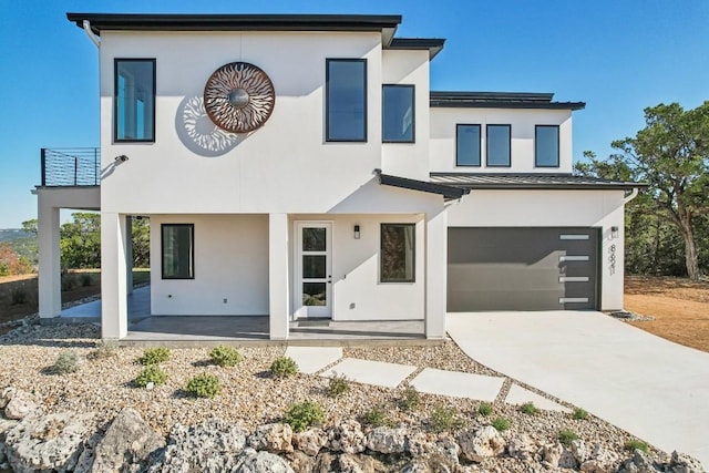 view of front of home featuring a balcony and a garage