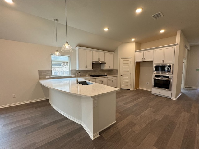 kitchen featuring stainless steel appliances, dark hardwood / wood-style floors, white cabinets, and decorative light fixtures