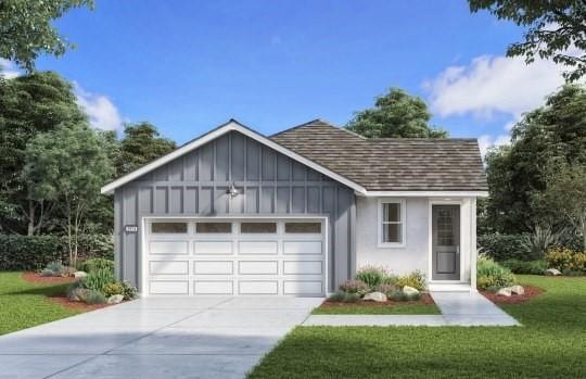 view of front of house featuring a front yard and a garage