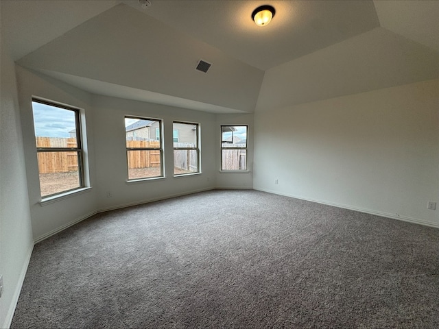 carpeted spare room featuring lofted ceiling