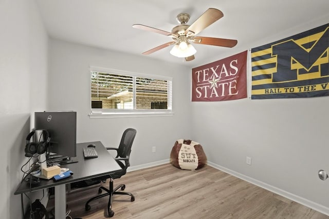 office area with baseboards, wood finished floors, and a ceiling fan