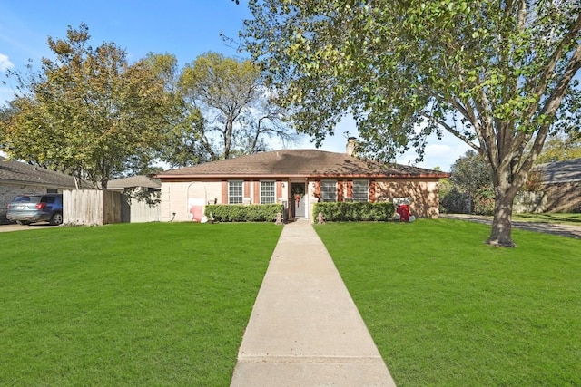 ranch-style home featuring a front yard