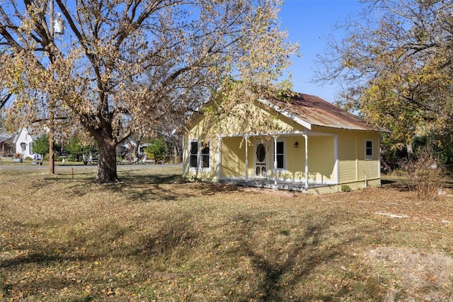 rear view of property with a porch