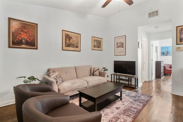 living room with dark hardwood / wood-style floors and ceiling fan