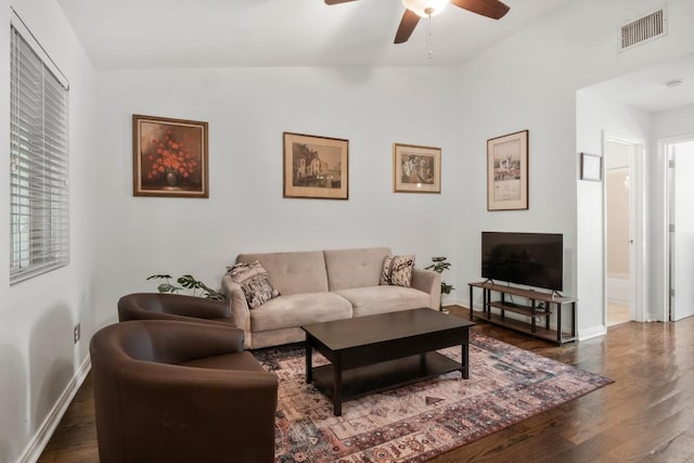 living room featuring dark hardwood / wood-style floors, ceiling fan, and lofted ceiling