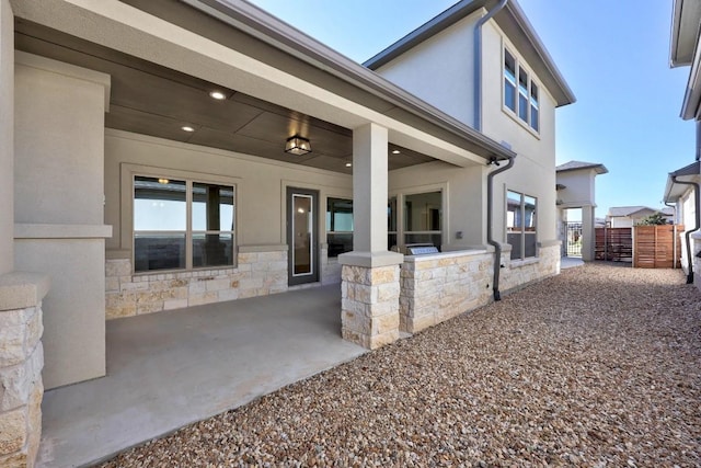 exterior space with an outdoor kitchen and a patio