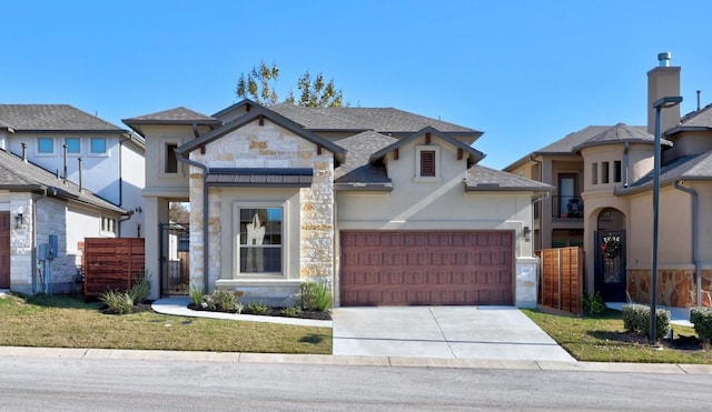 225 Skyflower Dr, Georgetown, TX 78628 - view of front of house featuring stone siding, concrete driveway, an attached garage, a shingled roof, and stucco siding