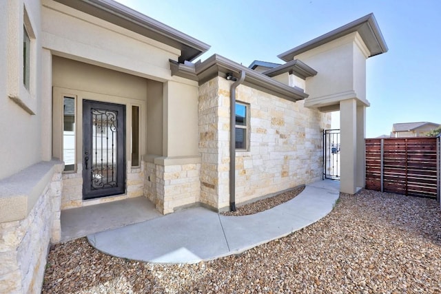 225 Skyflower Dr, Georgetown, TX 78628 - doorway to property featuring stone siding and a gate