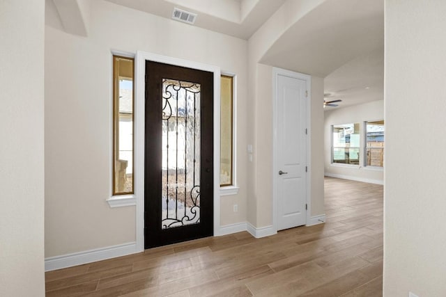 foyer with light hardwood / wood-style floors and ceiling fan