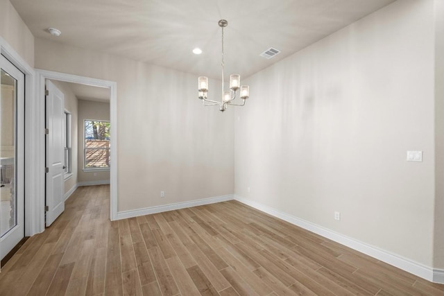 225 Skyflower Dr, Georgetown, TX 78628 - empty room featuring a chandelier, baseboards, light wood-style flooring, recessed lighting, and a smoke detector