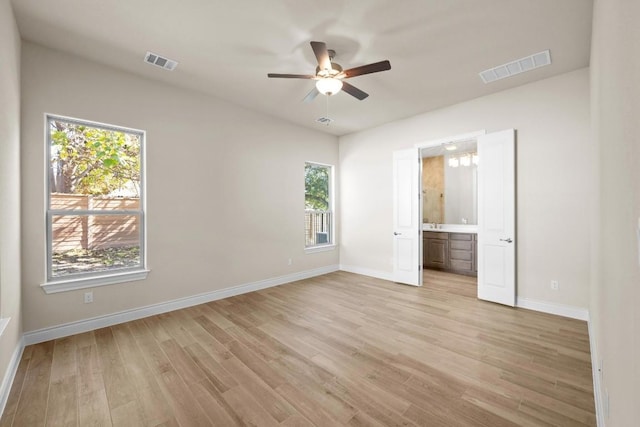 unfurnished bedroom featuring ceiling fan, connected bathroom, and light wood-type flooring