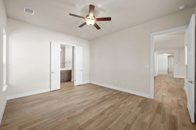 unfurnished bedroom with connected bathroom, ceiling fan, and light hardwood / wood-style flooring