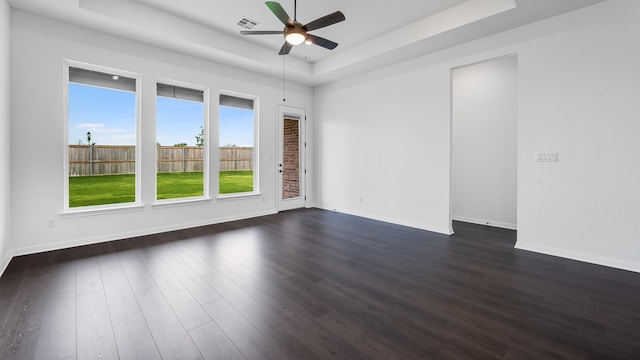 113 Golden Sage Ave, Georgetown, TX 78633 - spare room with a raised ceiling, ceiling fan, and dark wood-type flooring
