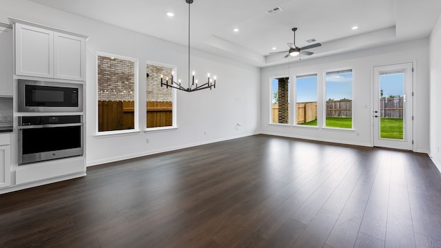 113 Golden Sage Ave, Georgetown, TX 78633 - unfurnished living room with a raised ceiling, dark wood-style floors, plenty of natural light, ceiling fan, and recessed lighting