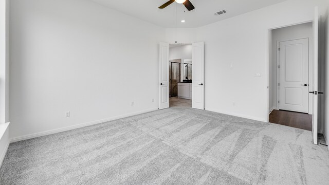 113 Golden Sage Ave, Georgetown, TX 78633 - unfurnished bedroom featuring carpet floors, connected bathroom, and a ceiling fan