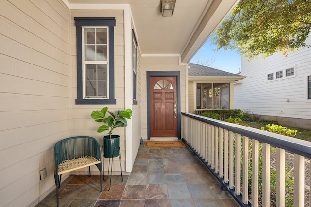 property entrance with roof with shingles