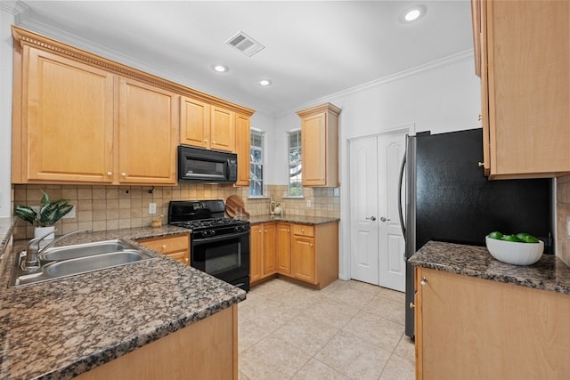 kitchen with crown molding, visible vents, decorative backsplash, a sink, and black appliances