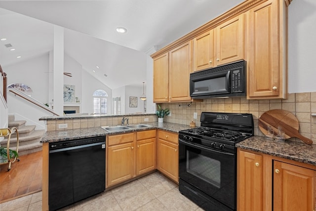 kitchen with tasteful backsplash, vaulted ceiling, a sink, a peninsula, and black appliances