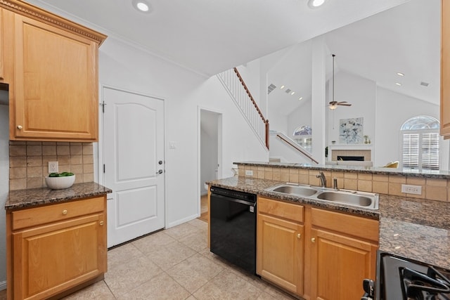 kitchen with ceiling fan, lofted ceiling, a sink, black dishwasher, and backsplash