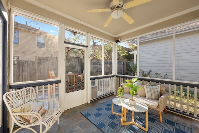 sunroom featuring plenty of natural light and a ceiling fan