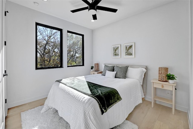 bedroom with ceiling fan and light wood-type flooring