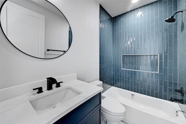 full bathroom featuring vanity, tiled shower / bath combo, and toilet