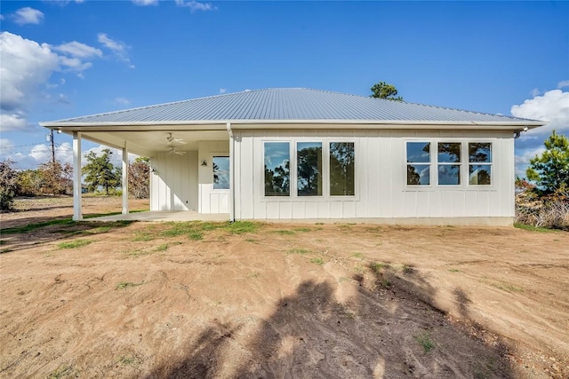 189 Mauna Kea Ln, Bastrop, TX 78602 - rear view of property with metal roof and board and batten siding
