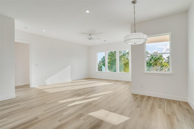 189 Mauna Kea Ln, Bastrop, TX 78602 - empty room featuring light wood-style floors, baseboards, a ceiling fan, and recessed lighting
