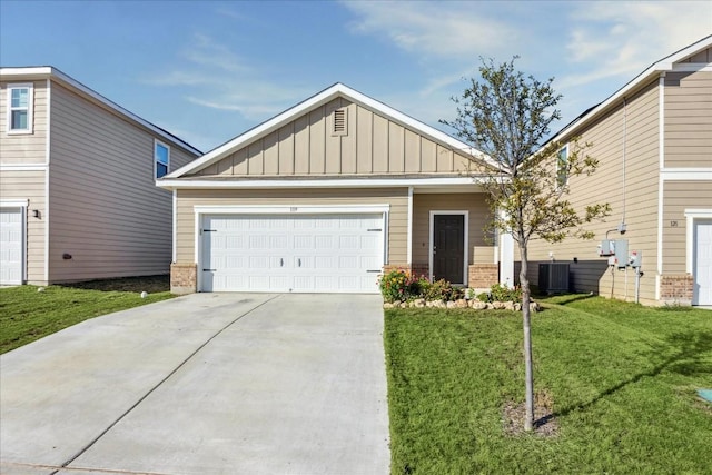 view of front of property with a front yard, a garage, and central AC unit