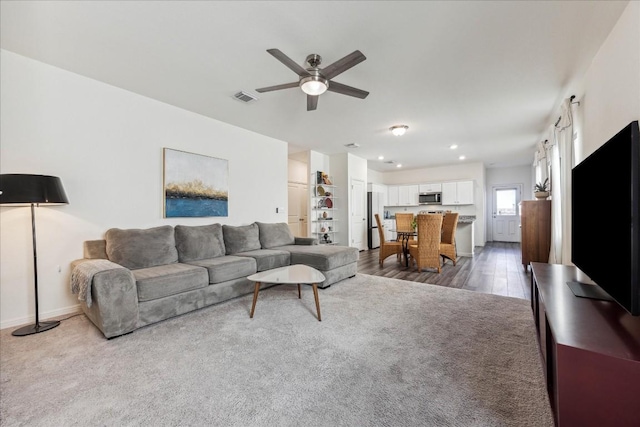 living room featuring ceiling fan and wood-type flooring