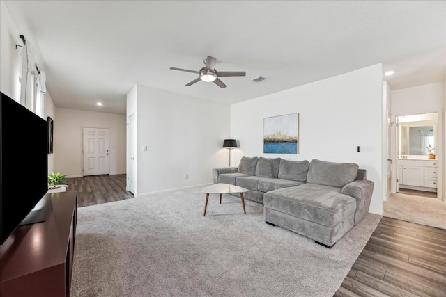 living room with hardwood / wood-style flooring and ceiling fan