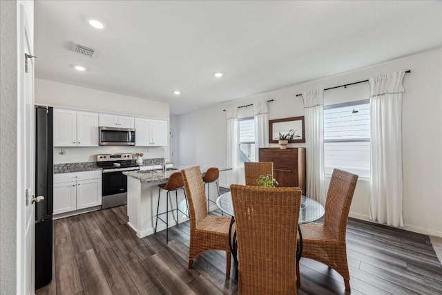 dining area featuring dark hardwood / wood-style flooring