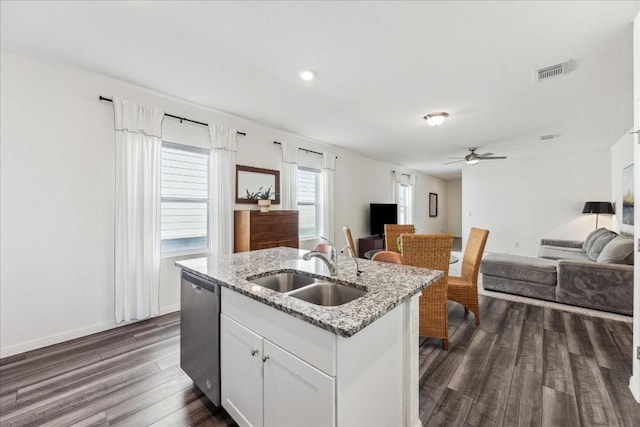 kitchen with dishwasher, sink, dark hardwood / wood-style floors, a kitchen island with sink, and white cabinets