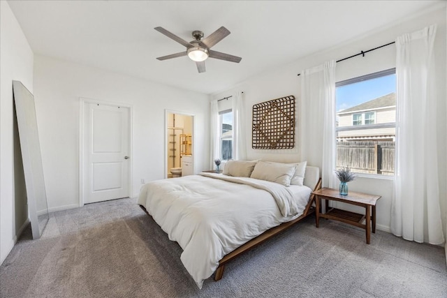 bedroom with connected bathroom, ceiling fan, and carpet