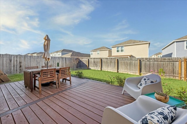 wooden deck featuring a lawn