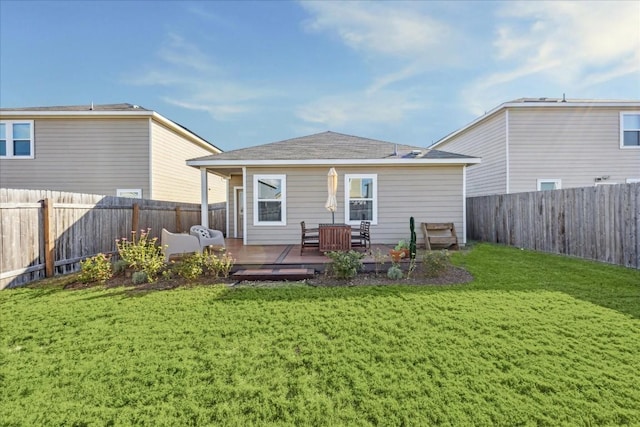 back of house featuring a wooden deck and a yard