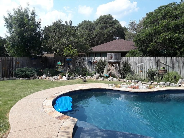 view of swimming pool featuring a fenced backyard, a fenced in pool, and a lawn