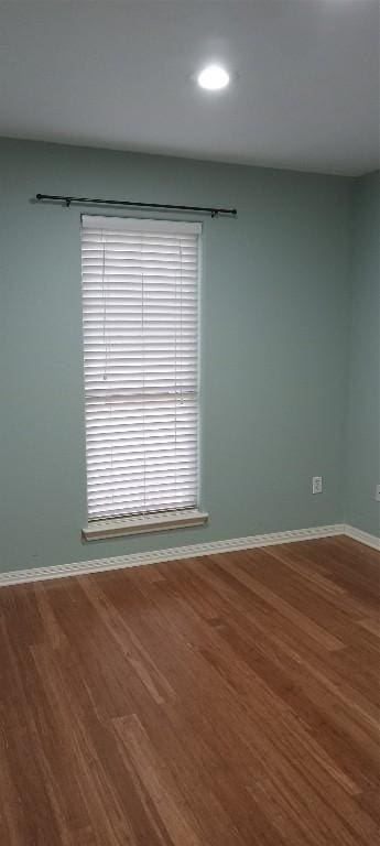 unfurnished room with wood-type flooring