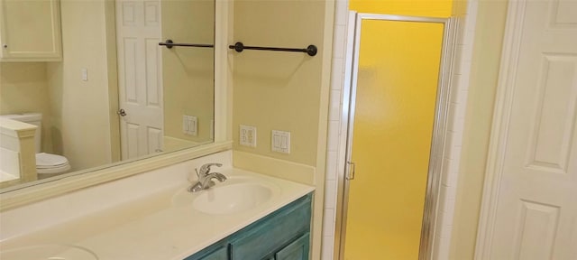 bathroom with vanity, toilet, and walk in shower