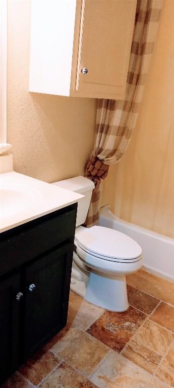 full bathroom featuring toilet, vanity, and shower / bath combo with shower curtain