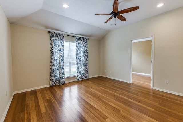 unfurnished room featuring a ceiling fan, baseboards, recessed lighting, wood finished floors, and vaulted ceiling