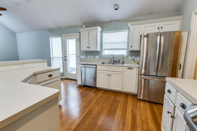 kitchen featuring light countertops, a sink, white cabinets, and stainless steel appliances