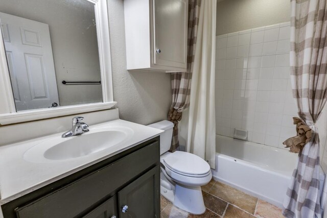 bathroom with vanity, shower / bath combo, and toilet
