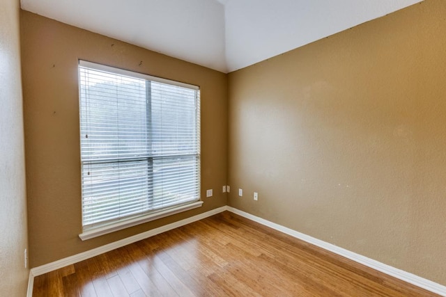 unfurnished room with baseboards and wood finished floors