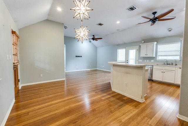 kitchen with visible vents, a ceiling fan, lofted ceiling, and dishwasher
